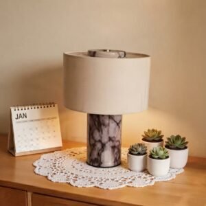 Marble table lamp with fabric shade on wooden nightstand