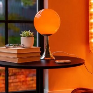 Nordic glass globe lamp glowing warm amber on nightstand
