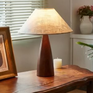 Retro iron desk lamp with fabric shade on wooden desk