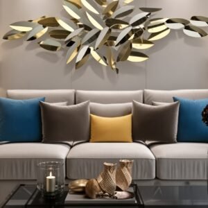 Gold leaf metal wall art with a high gloss finish hanging above a sofa in a living room