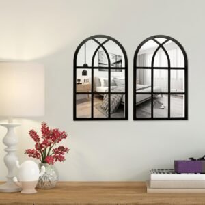 Set of 2 arched window mirrors stuck on a dining room wall above a wooden sideboard