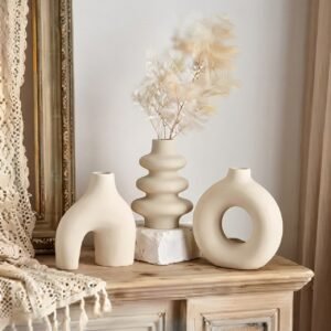 Decorative boho ceramic vase set in neutral tones on a living room coffee table