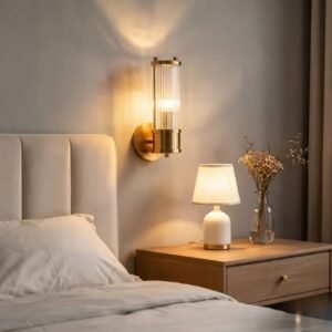 Modern crystal LED wall light with minimalist frame mounted beside a bed