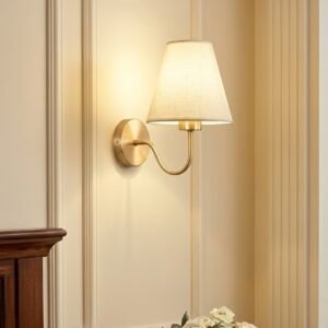 Retro fabric wall lamp with soft glow mounted beside a bed