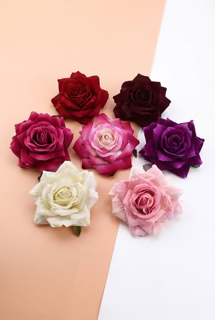 Pile of soft flannel rose flower heads in mixed colours for DIY crafts