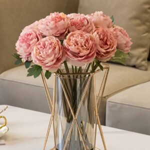 Geometric glass vase with wrought iron frame on a dining table